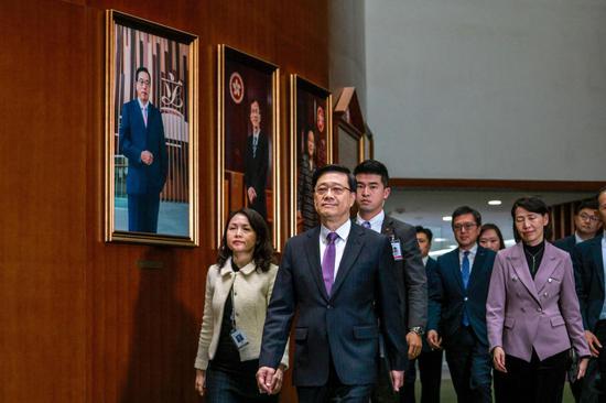 Chief Executive John Lee Ka-chiu arrives at the Legislative Council chamber after the passage on third reading of the Safeguarding National Security Ordinance on March 19,<strong></strong> 2024. (ANDY CHONG/CHINA DAILY)