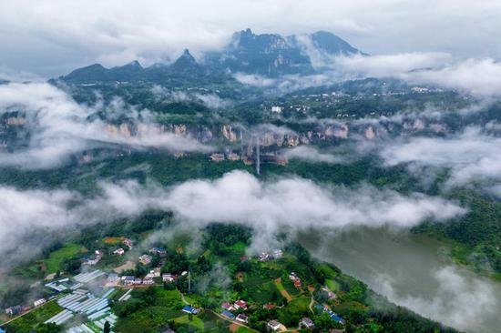 Clouds floating over Qingjaing River creates ecological picture after rain