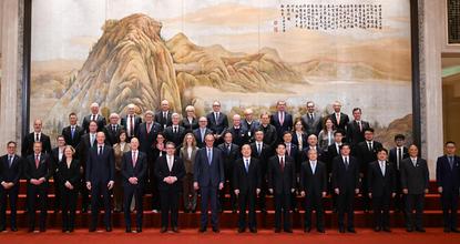 German Chancellor Merz poses with business representatives from Germany, China