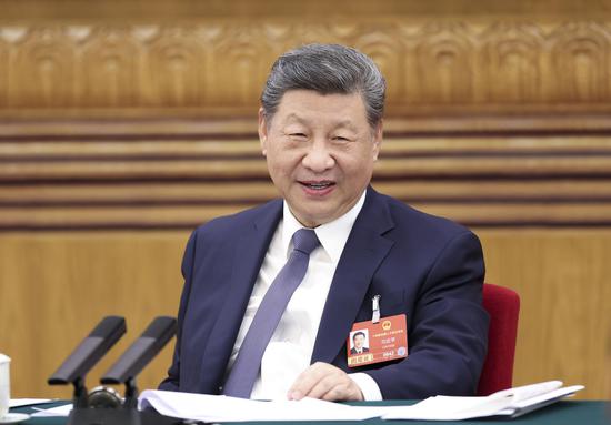 Xi takes part in deliberation with his fellow deputies from delegation of Jiangsu Province