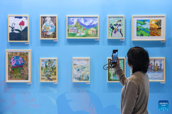 A visitor records a video at an exhibition during the Green and Sustainable Development Forum of the Shanghai Cooperation Organization (SCO) in Ningbo, east China's Zhejiang Province on April 29, 2026.  (Xinhua/Jiang Han)