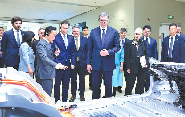 Serbian President Aleksandar Vucic, who is on a state visit to China, inspects Xiaomi's auto factory in Beijing on Tuesday. He learned about the latest progress made by the Chinese technology enterprise in intelligent manufacturing and industrial innovation. (WANG JING/CHINA DAILY)