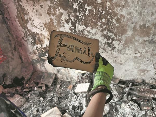A hand-drawn picture of the word "Family" is found after Gabby and her husband Antonio sifted through their fire-damaged apartment.