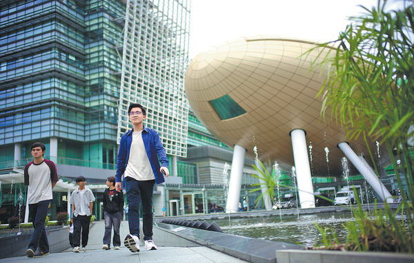 People stroll by the Charles K. Kao Auditorium, also known as the Golden Egg, inside the Hong Kong Science Park on Tuesday. EDMOND TANG/CHINA DAILY
