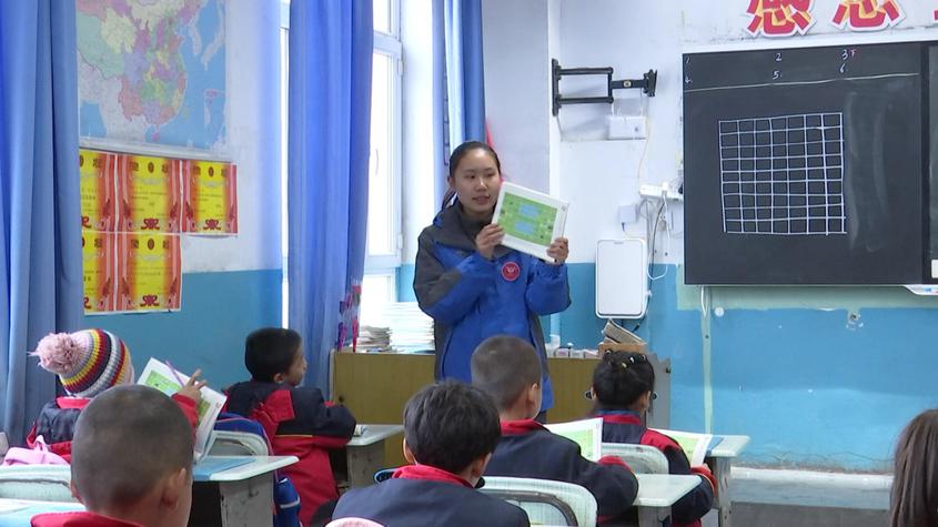 小学的操场上,湖北文理学院"雪莲花"团队的支教老师张宗超正在给学生