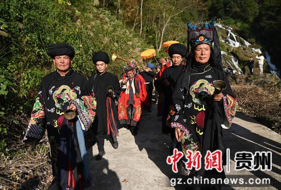 11月25日，在松桃苗族自治县盘石镇响水洞村，村民在举行“接龙”活动。 谢慧芳摄
