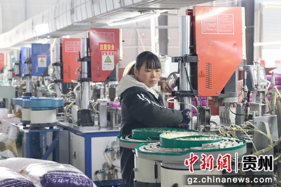 贵州杰博电气科技有限公司生产车间内,工人在生产线上赶制订单。唐鹏摄