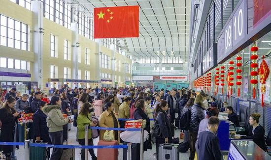 2月20日，和田昆冈机场值机大厅内旅客有序排队办理登机牌。阿卜力克木 摄