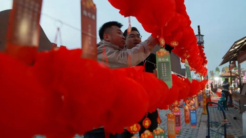 柯坪县元宵节赏群众正在猜灯谜 高依然 摄

　　