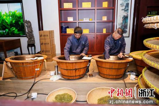 图为：茶农在炒制新鲜的西湖龙井茶。中新社发 李姹红 摄
