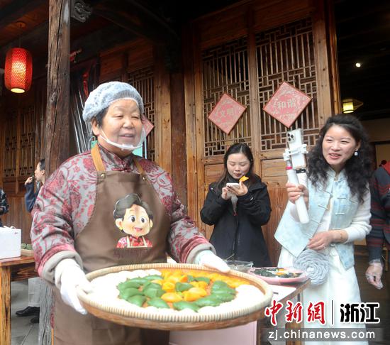 
图为：清明馃制作技艺比赛第一名的作品引人拍摄。中新社发 张黎明 摄