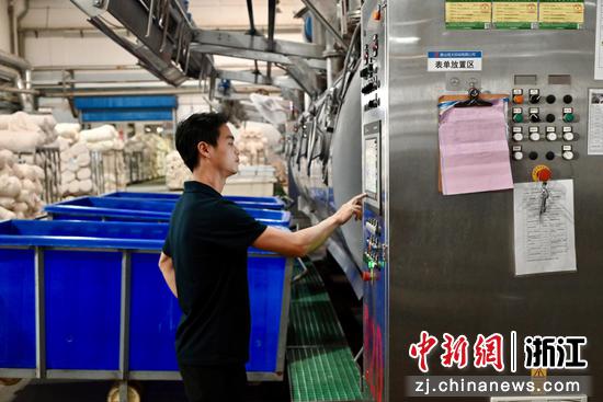 
图为工作人员检查超低浴比染色机运行程序。中新社发 骆泽明 摄