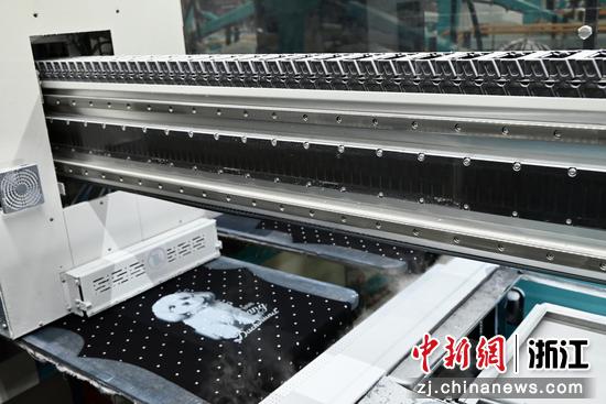图为数码喷印机在衣片上喷绘图案。中新社发 骆泽明 摄