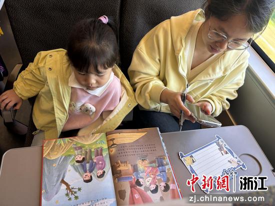 图为：小朋友在车厢内阅读。中新社发 高艳 供图