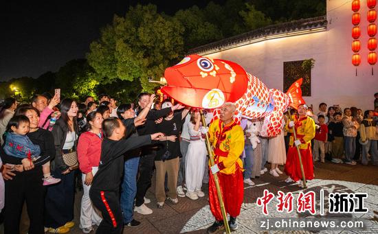 图为众多游客热情高涨，争相摸鱼头，渴望鸿运当头。沈勇强 摄