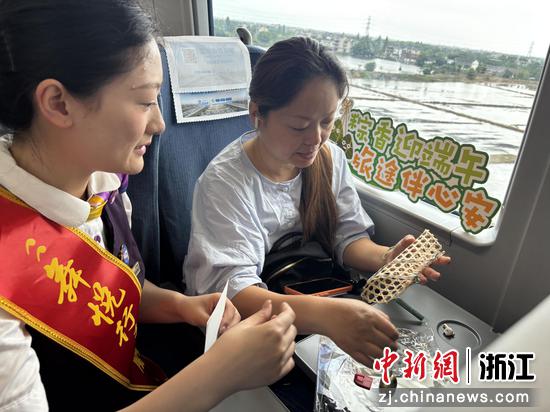 图为：乘务员和旅客进行手工制作。中新社发 高艳 摄